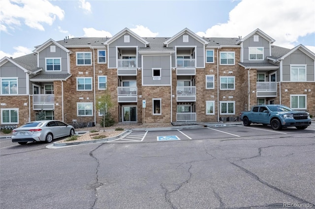 1881 S Dunkirk St Unit 106, Aurora, CO 80017 - view of property featuring uncovered parking