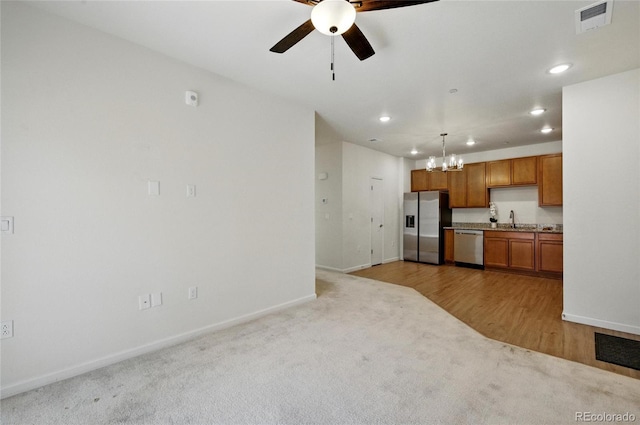 1881 S Dunkirk St Unit 106, Aurora, CO 80017 - kitchen with baseboards, light colored carpet, recessed lighting, a sink, and stainless steel appliances