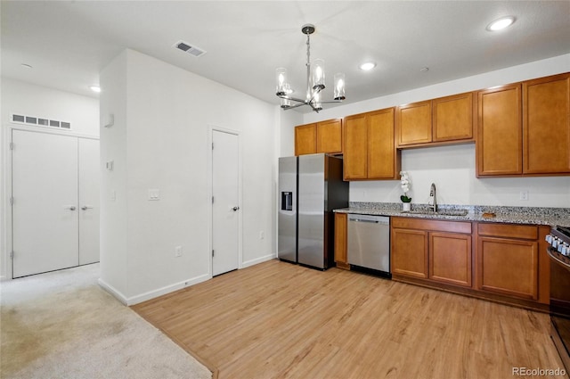1881 S Dunkirk St Unit 106, Aurora, CO 80017 - kitchen with visible vents, a sink, appliances with stainless steel finishes, and brown cabinets