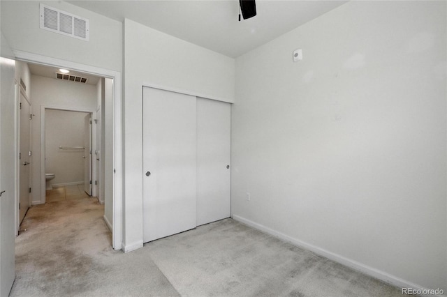 1881 S Dunkirk St Unit 106, Aurora, CO 80017 - unfurnished bedroom featuring baseboards, light carpet, a closet, and visible vents