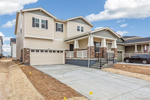 20724 E 57th Ave, Aurora, CO 80019 - craftsman inspired home featuring stone siding, driveway, covered porch, and a garage