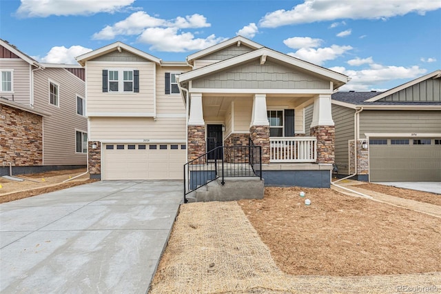 20724 E 57th Ave, Aurora, CO 80019 - craftsman-style house with concrete driveway, stone siding, covered porch, and an attached garage