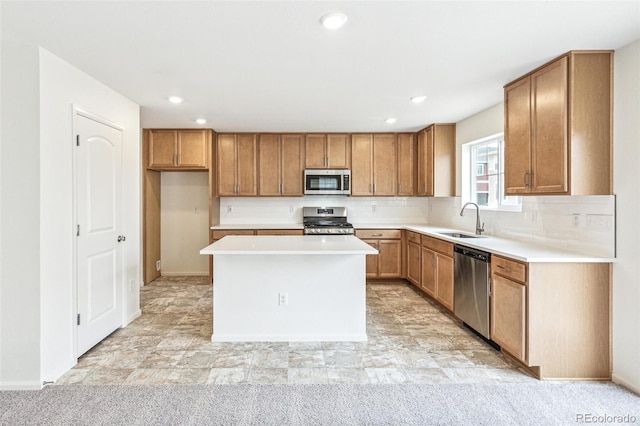 20724 E 57th Ave, Aurora, CO 80019 - kitchen with stainless steel appliances, a sink, brown cabinets, a center island, and recessed lighting