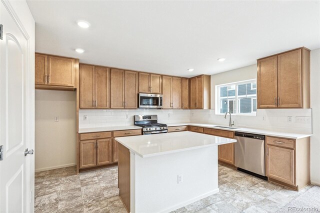 20724 E 57th Ave, Aurora, CO 80019 - kitchen with stainless steel appliances, a sink, brown cabinets, backsplash, and recessed lighting