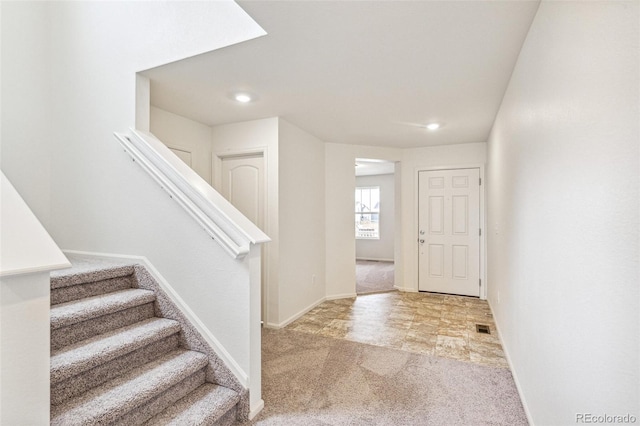 20724 E 57th Ave, Aurora, CO 80019 - carpeted foyer featuring stairs, baseboards, and recessed lighting
