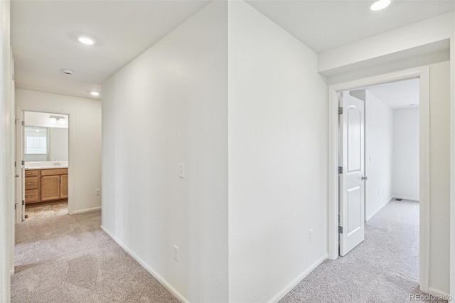 20724 E 57th Ave, Aurora, CO 80019 - corridor featuring light colored carpet, baseboards, and recessed lighting
