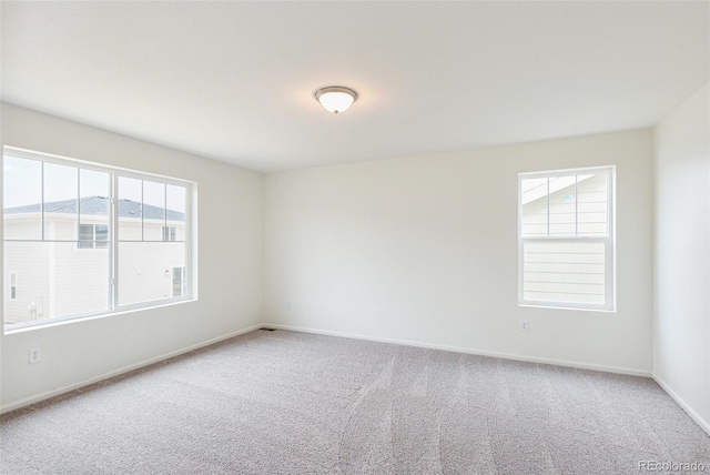 20724 E 57th Ave, Aurora, CO 80019 - empty room featuring carpet flooring, healthy amount of natural light, and baseboards