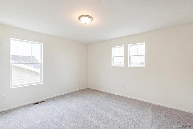 20724 E 57th Ave, Aurora, CO 80019 - spare room with healthy amount of natural light, carpet floors, and baseboards