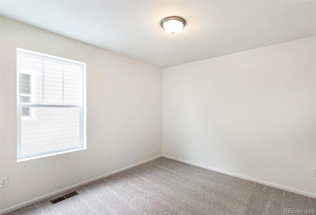 20724 E 57th Ave, Aurora, CO 80019 - unfurnished room with carpet flooring, baseboards, and plenty of natural light