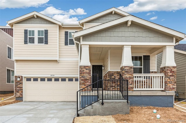 20724 E 57th Ave, Aurora, CO 80019 - craftsman house with stone siding, concrete driveway, covered porch, and a garage