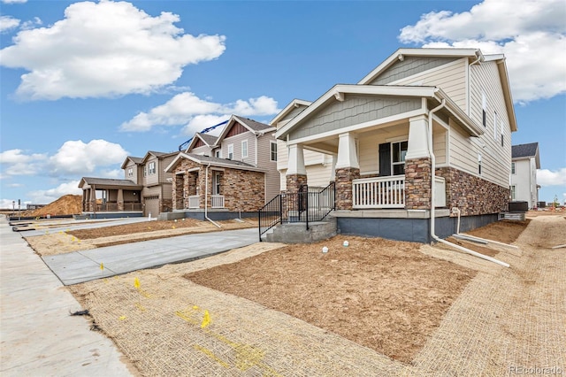 20724 E 57th Ave, Aurora, CO 80019 - craftsman inspired home with covered porch, stone siding, and concrete driveway