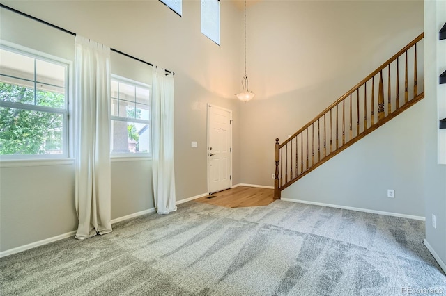13018 Niagara Way, Thornton, CO 80602 - carpeted entrance foyer featuring stairway and a towering ceiling