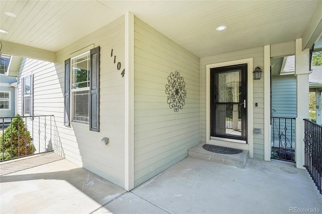 view of exterior entry featuring covered porch