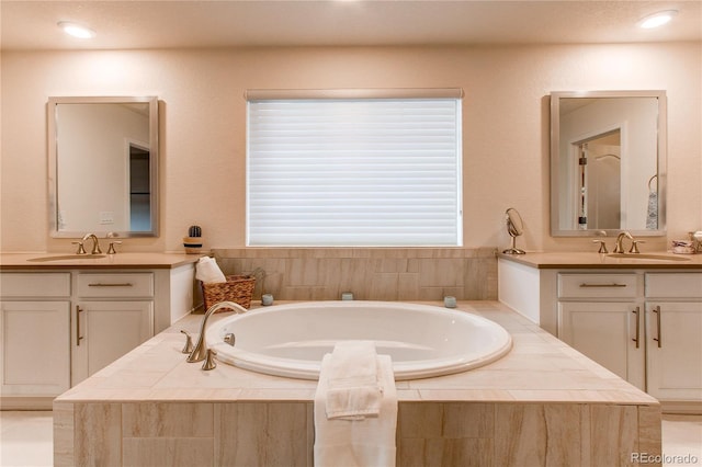 8107 Arapahoe Peak St, Littleton, CO 80125 - full bath with two vanities, a garden tub, and recessed lighting