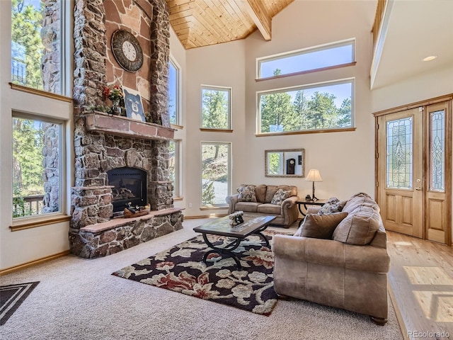 living room with plenty of natural light, wooden ceiling, and a fireplace