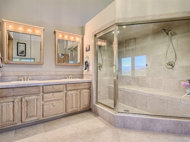 bathroom with walk in shower, vanity, and tile patterned flooring