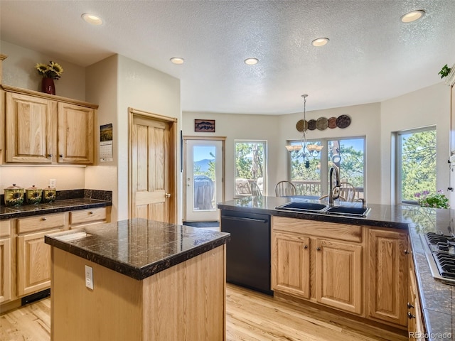 kitchen with black dishwasher, sink, a center island with sink, and light hardwood / wood-style flooring