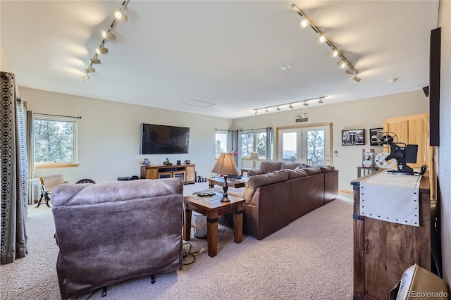 carpeted living room with rail lighting