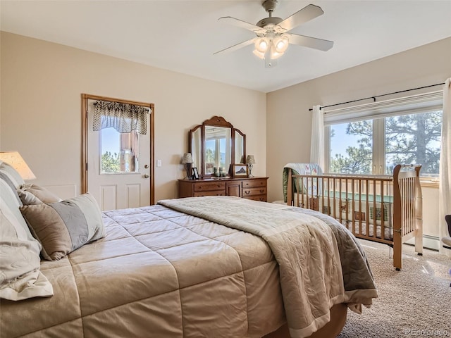 carpeted bedroom with multiple windows and ceiling fan