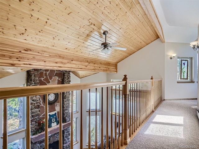 hall with carpet, vaulted ceiling with beams, and wood ceiling