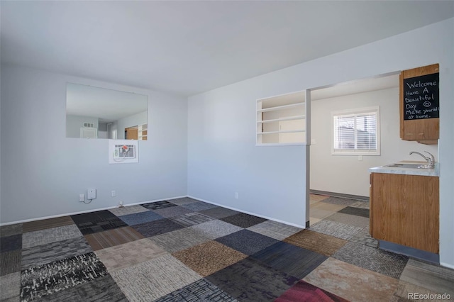 empty room featuring a sink and baseboards