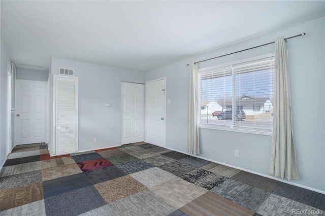 bedroom with baseboards and visible vents