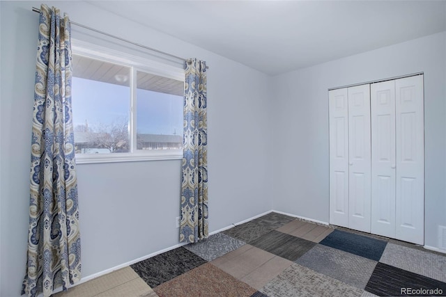 unfurnished bedroom featuring a closet, visible vents, and baseboards