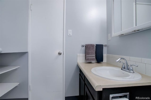 bathroom with decorative backsplash and vanity