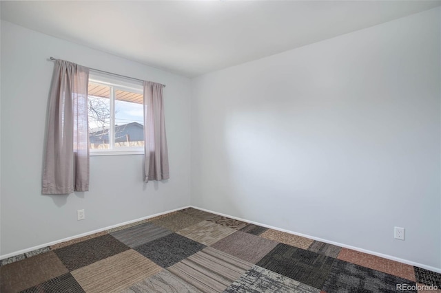 empty room with baseboards and carpet floors