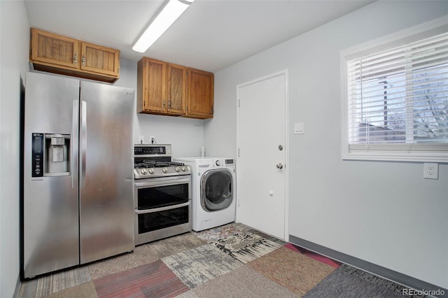 washroom with laundry area and washer / dryer