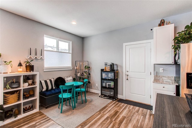 game room with light wood-type flooring and baseboards