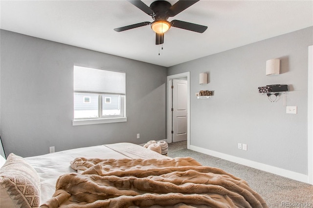 bedroom with light colored carpet, ceiling fan, and baseboards