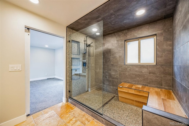 bathroom with a tile shower