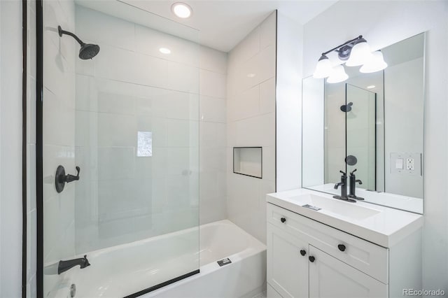 bathroom with vanity and tiled shower / bath combo