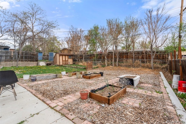 741 Cortez St, Denver, CO 80221 - view of yard featuring an outdoor structure, a storage shed, a fenced backyard, and a vegetable garden