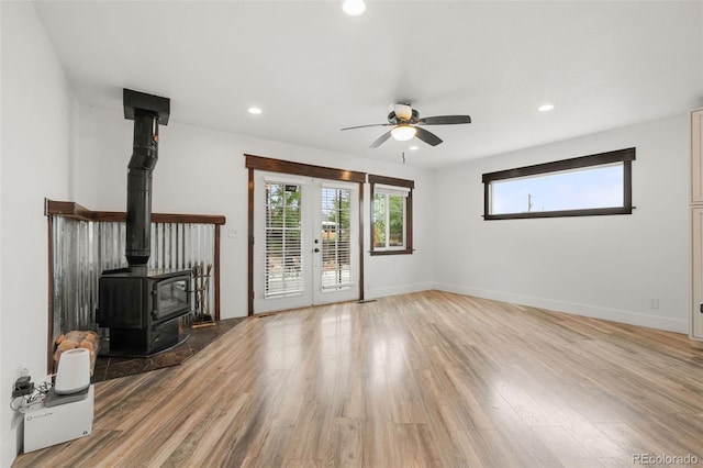 741 Cortez St, Denver, CO 80221 - unfurnished living room with a wood stove, ceiling fan, light wood-style flooring, recessed lighting, and baseboards