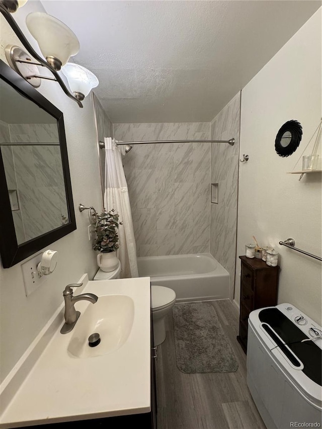 full bath with a textured ceiling, toilet, wood finished floors, vanity, and shower / bath combo with shower curtain