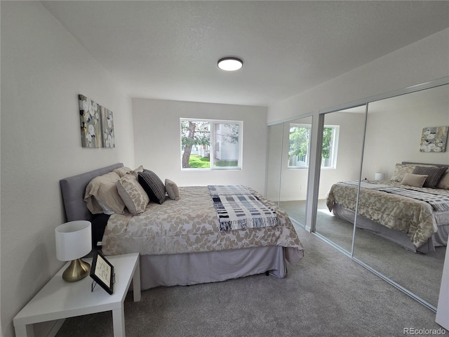 14433 E Jewell Ave Unit 101, Aurora, CO 80012 - bedroom featuring two closets and carpet floors