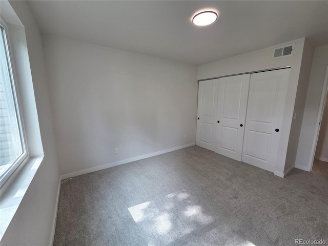 14433 E Jewell Ave Unit 101, Aurora, CO 80012 - unfurnished bedroom featuring carpet and a closet