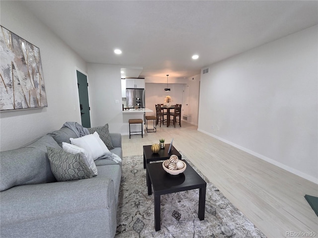 14433 E Jewell Ave Unit 101, Aurora, CO 80012 - living area featuring light wood-type flooring and recessed lighting