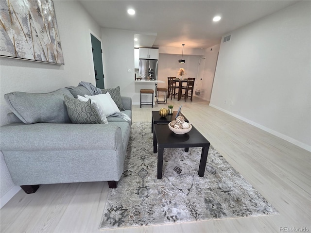 14433 E Jewell Ave Unit 101, Aurora, CO 80012 - living room with light wood-style floors and recessed lighting