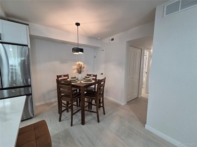 14433 E Jewell Ave Unit 101, Aurora, CO 80012 - dining room featuring baseboards and light wood finished floors