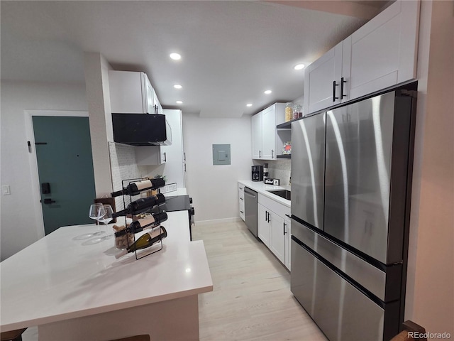 14433 E Jewell Ave Unit 101, Aurora, CO 80012 - kitchen featuring stainless steel appliances, open shelves, decorative backsplash, electric panel, and light wood-type flooring