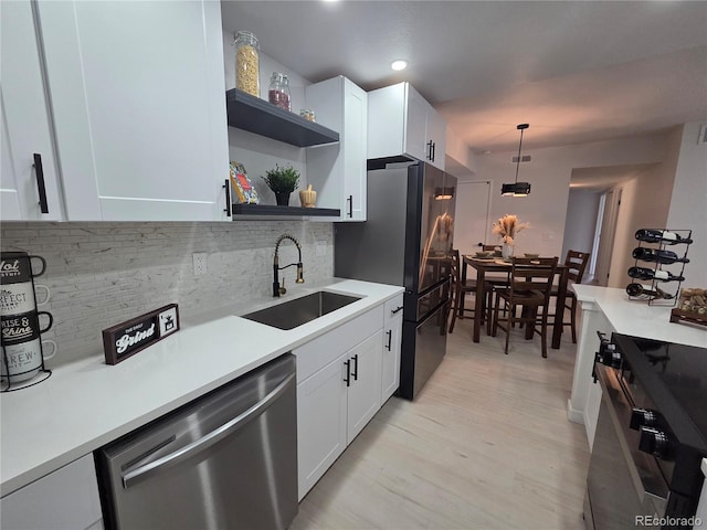 14433 E Jewell Ave Unit 101, Aurora, CO 80012 - kitchen with dishwasher, range, open shelves, decorative backsplash, and white cabinets