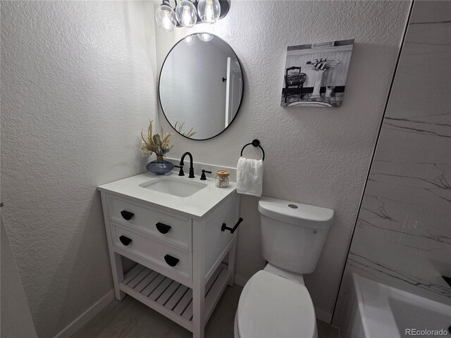 14433 E Jewell Ave Unit 101, Aurora, CO 80012 - bathroom featuring vanity, a tub, and a textured wall