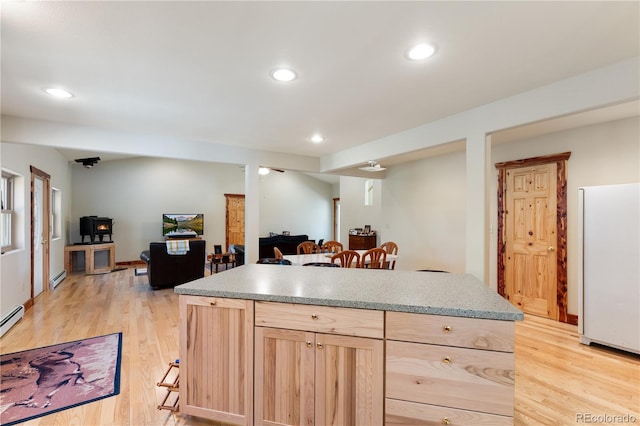 33002 Bobcat Ct, Trinidad, CO 81082 - kitchen with freestanding refrigerator, light brown cabinetry, open floor plan, light wood-style floors, and recessed lighting