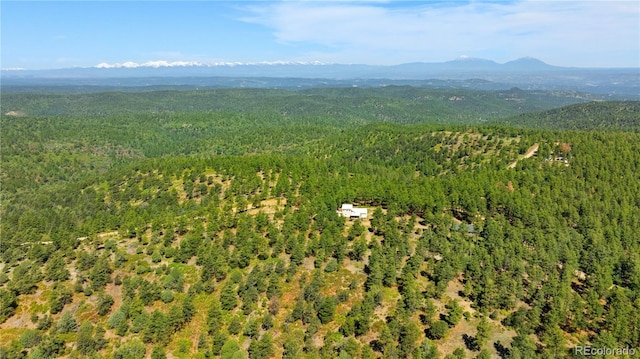 33002 Bobcat Ct, Trinidad, CO 81082 - aerial view of property and surrounding area featuring a heavily wooded area and a mountain backdrop