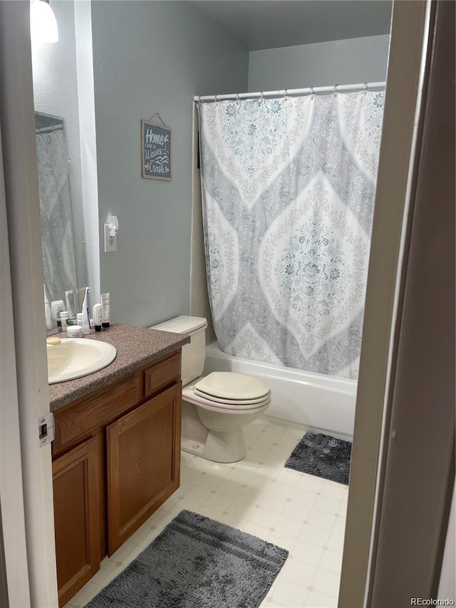 bathroom featuring toilet, vanity, and shower / tub combo