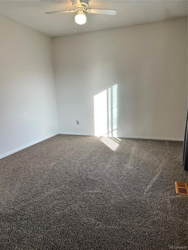 spare room with visible vents, a textured ceiling, ceiling fan, and carpet flooring