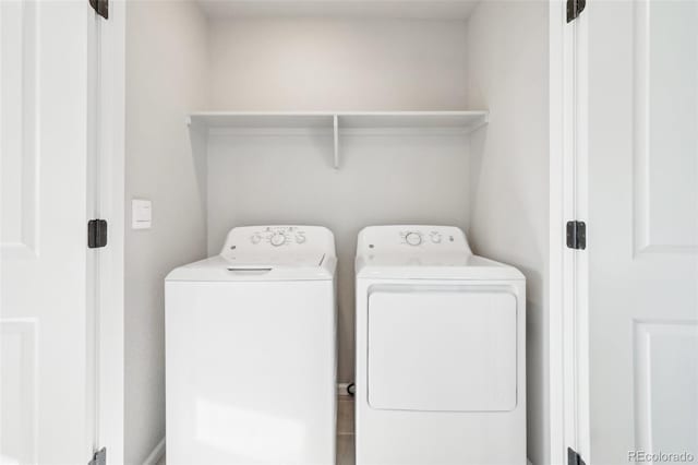 clothes washing area with washing machine and clothes dryer